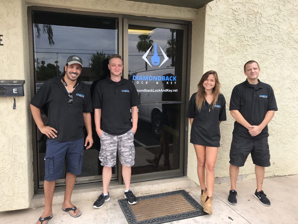 A locksmith from Diamondback Lock and Key working on a commercial door lock, representing professional locksmith services for businesses in Phoenix and surrounding cities. The image showcases tools and expertise in securing business premises.