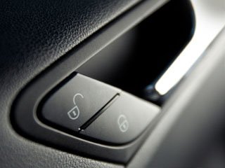 Close-up of a car’s interior door handle and lock buttons