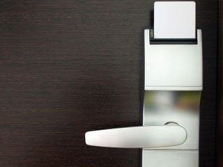 A commercial lever lock with an electronic reader on a business door